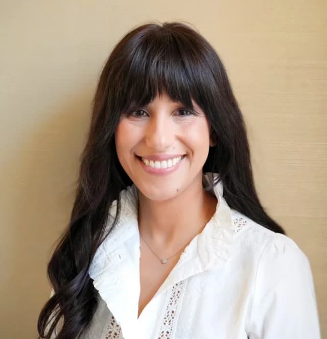 Dr Caridi headshot in white shirt